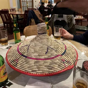 a large woven hat on a table