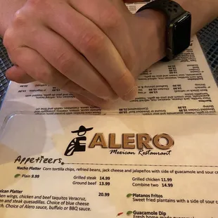 a person&apos;s hand on a menu