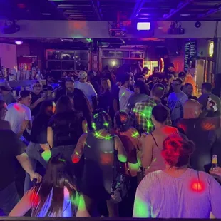 a large group of people dancing at a party