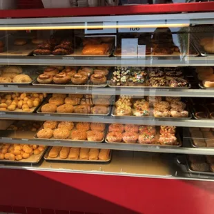 a variety of donuts in a display case