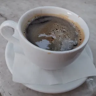 a cup of coffee on a saucer