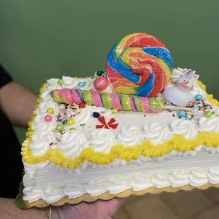 a cake with a lollipop on top