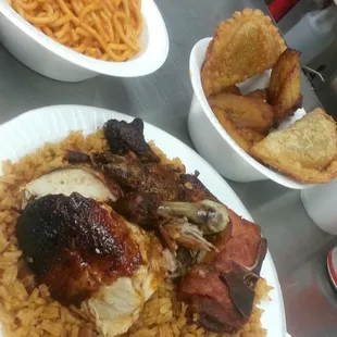 Rotisserie Chicken with Gallo Pinto (Rice), Pork Chops, side of Spaghetti, meat Empenada, &amp; Platano fritos. Super delish about $10 bucks