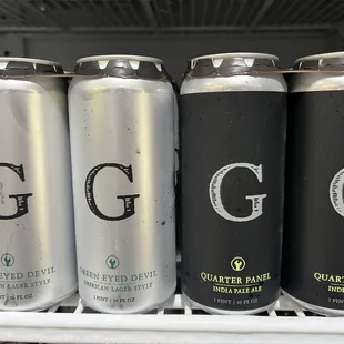 six cans of beer on a shelf