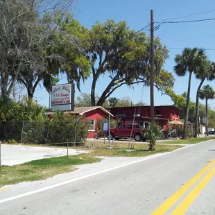 a red truck parked in front of a restaurant