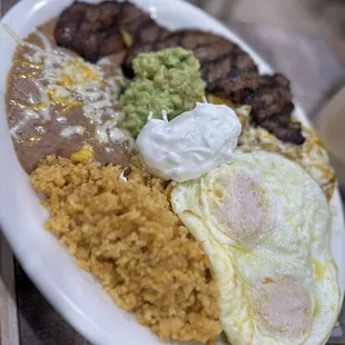 Chilaquiles green sauce, steak and a sunny side egg