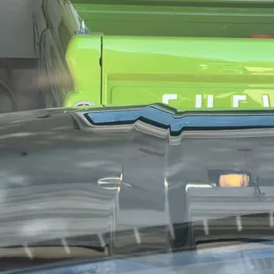 Dent in the crease of the hood looking down the hood.