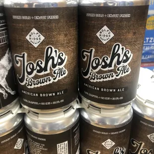 a stack of cans of josh&apos;s brown ale