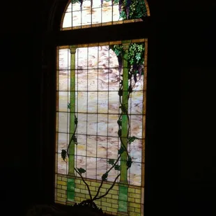 Original stained glass window at the grand stair, stands over 10 ft tall.