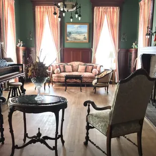 The Library with original, light fixtures, stained glass doors on the book shelves, and a bronze fireplace.