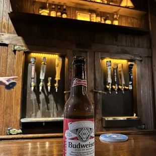 a bottle of budweier beer on a table
