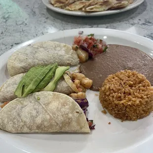 Shrimp tacos, refried beans and rice