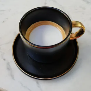 Espresso Macchiato. Very strong flavor, but served in a laughably huge cup (standard coffee mug).