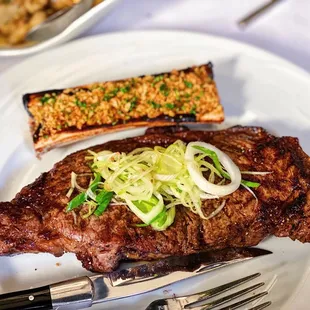 Australian wagyu strip topped with negi and a side of bone marrow