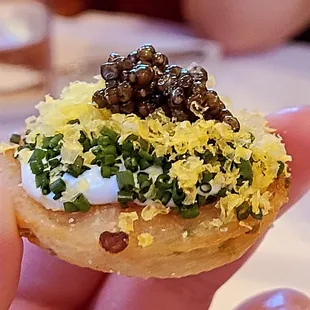 Caviar Service - scallion pancake with creme fraiche, chives, shaved egg yolk, white sturgeon caviar