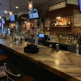 a bar with people sitting at the bar