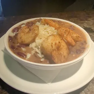 The Cajun: Four spicy shrimp served over rice in house made slow cooked spiced red beans.