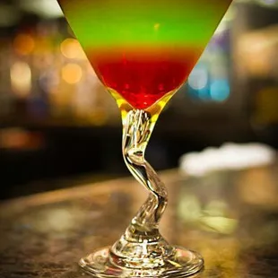 a colorful drink in a martini glass
