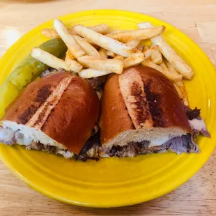 a sandwich and fries on a yellow plate