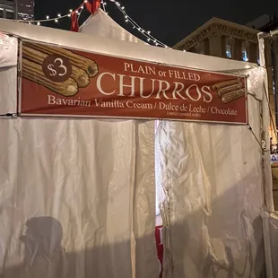 a tent with a sign that says 3 churros