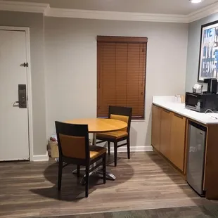 Dining area with microwave, mini fridge and coffee maker.