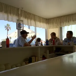 a group of people sitting at a counter