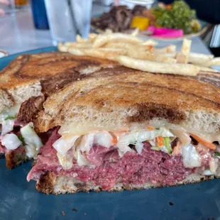 a corned beef sandwich with fries