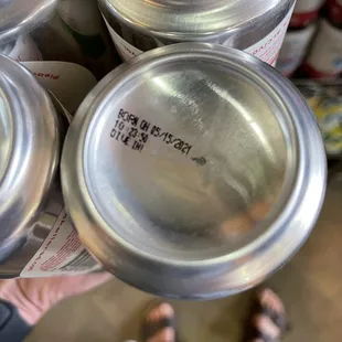 a person holding a can of beer