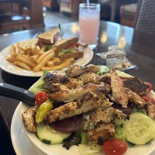 a plate of chicken salad and french fries
