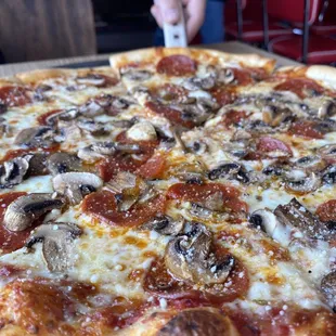 Medium pepperoni and mushroom pizza