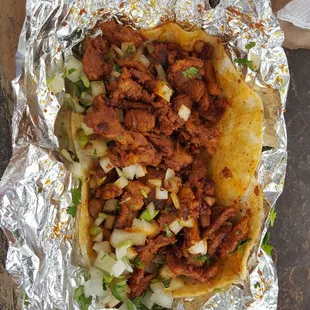 Al Pastor taco.  Has three tortillas, kind of a double wide taco!