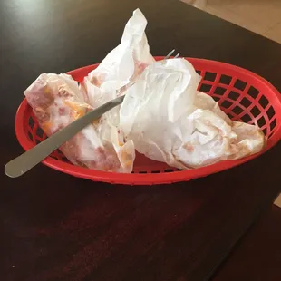 a red basket of food on a table