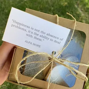 a person holding a box of soap