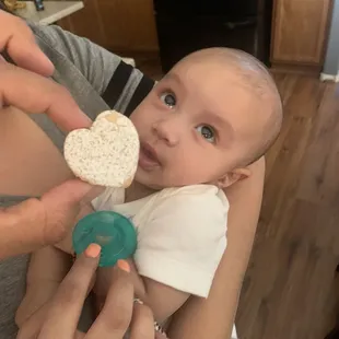 a woman holding a baby in her arms