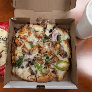 Personal chicken gourmet pizza with a soda and chips. Super creamy!