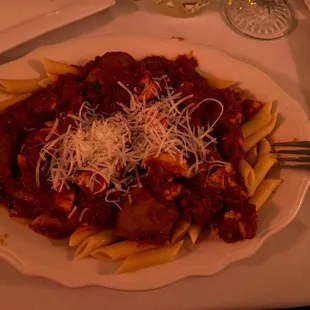 a plate of pasta with meat and cheese