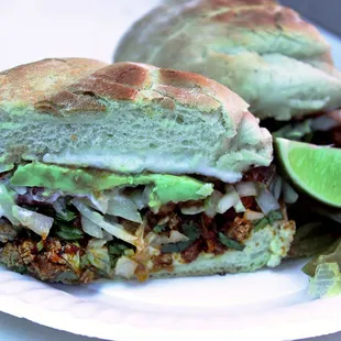 One of our specialities! Torta de adobada! elera bread; your choice of meat, onion, cilantro, lettuce, tomato, salsa,guacamole