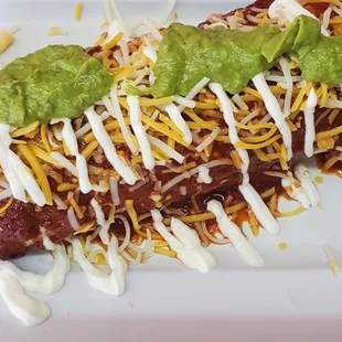 an enchilado with cheese and guacamole