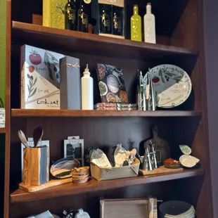 a shelf of olive oil and balsamics