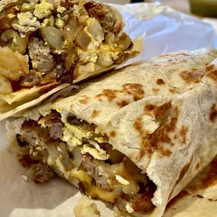 Egg, sausage, potato &amp; cheese breakfast burrito. Huge!  And with a little salt &amp; tomatillo salsa, hugely delicious!!!