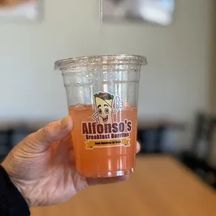 a person holding a cup of food