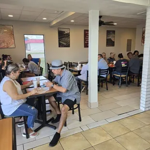 Dining area with about 12 tables for 2, and 2 tables that fit 4-6. You can push tables together for bigger party.