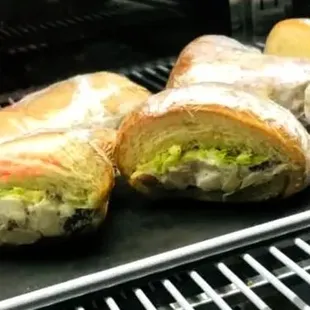 a bunch of sandwiches on a grill