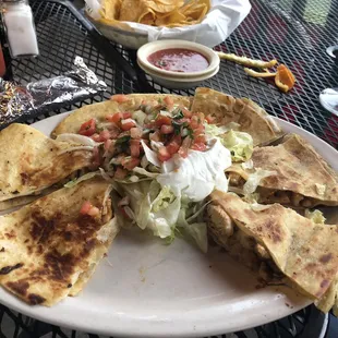 Mexican pizza minus one piece. This is the large one comes with lettuce, pico guac and sour cream.