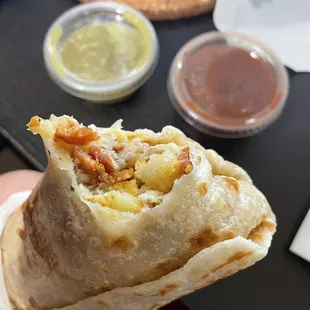 a hand holding a burrito