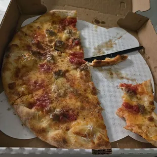 Half eaten sausage pizza