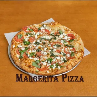 Margherita Pizza.
Fresh Roma tomatoes, basil, buffalo mozzarella cheese in olive oil and fresh garlic sauce.