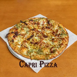 Capri Pizza.
Pesto, sun dried tomatoes, in garlic and olive oil.