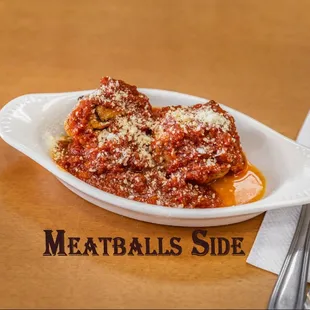 Meatballs Side.
Ground meat rolled into small spheres, prepared with bread crumbs, minced onion, eggs, butter, and seasoning.