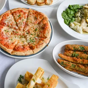 a pizza and other food items